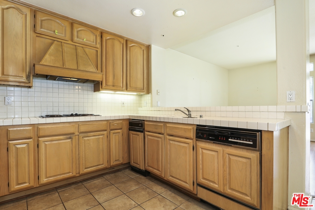 889 C. Amable Glendale, CA 91208 - Photo 13 of 51 a kitchen with stainless steel appliances granite countertop a sink and cabinets