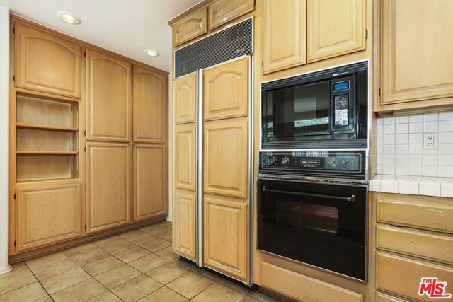 a kitchen with granite countertop cabinets and steel stainless steel appliances