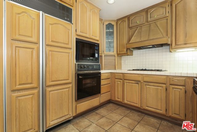 wooden floor fireplace and windows in an empty room