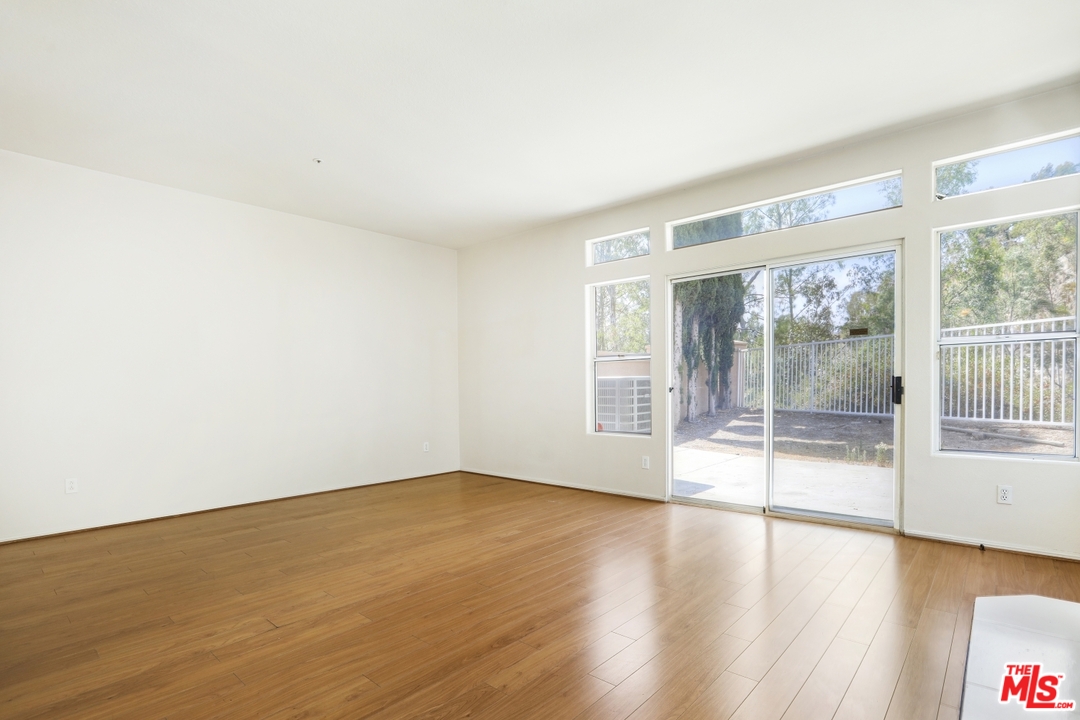 889 C. Amable Glendale, CA 91208 - Photo 18 of 51 an empty room with wooden floor and windows