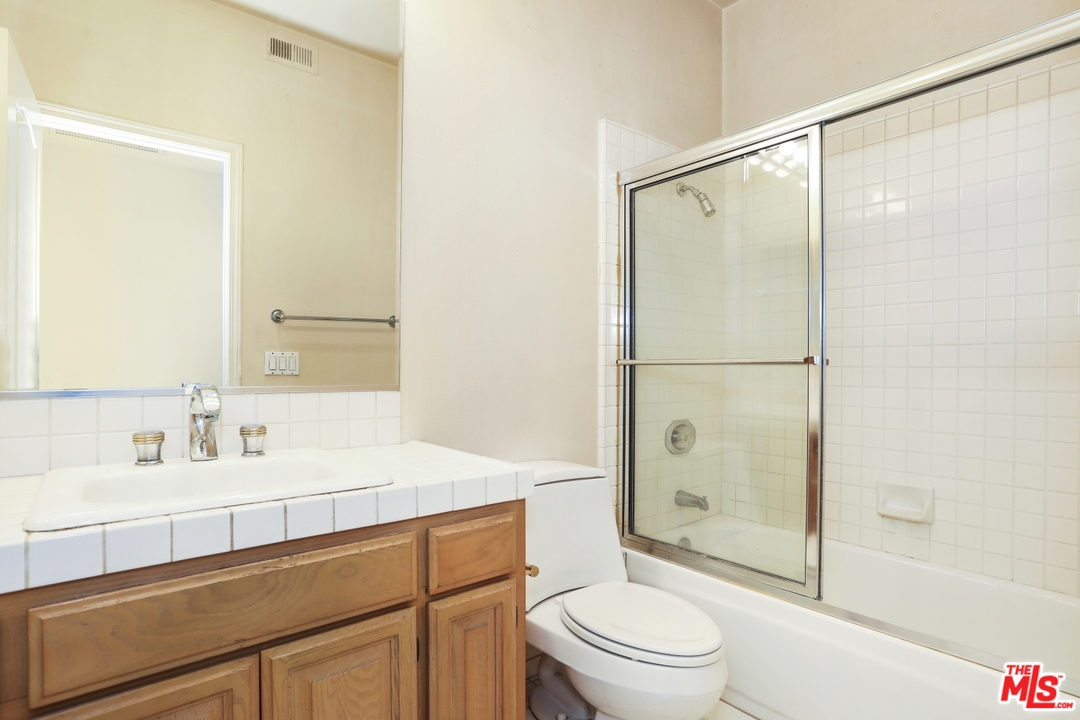 889 C. Amable Glendale, CA 91208 - Photo 34 of 51 a bathroom with a shower sink vanity mirror and toilet