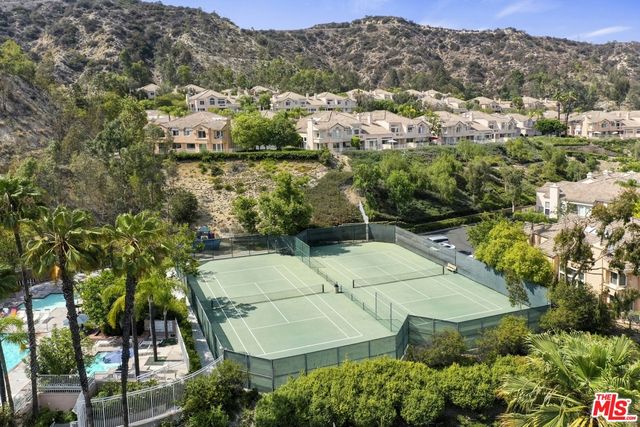 an aerial view of residential houses with outdoor space and street view
