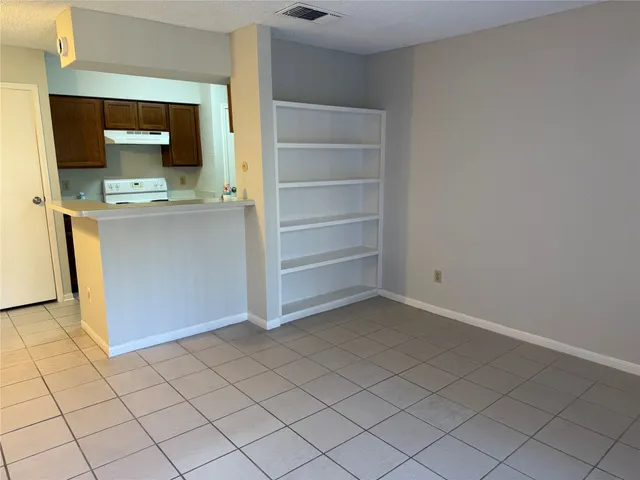 a view of a livingroom with an empty space and a window