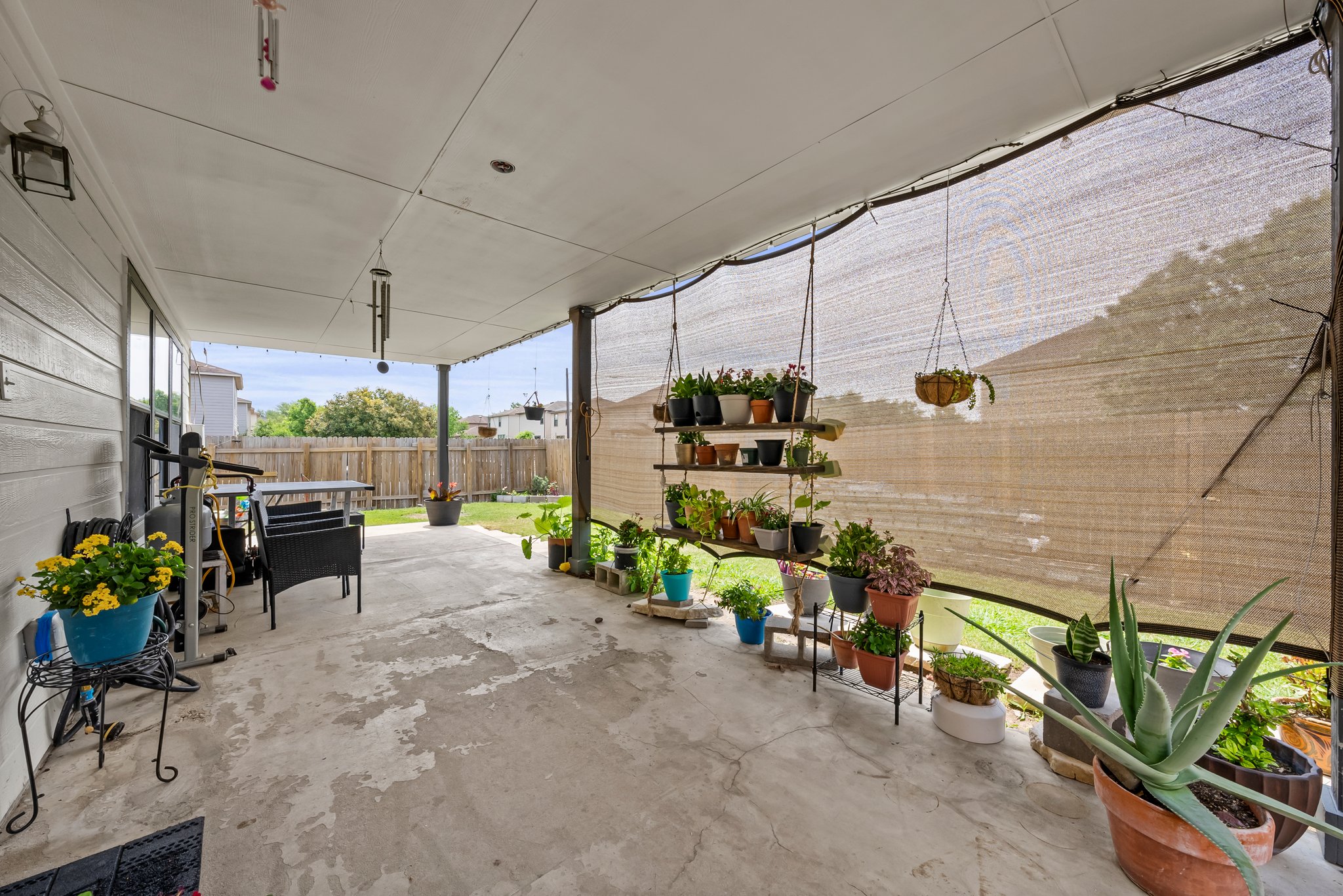 6829 Walkup Lane Austin, TX 78747 - Photo 15 of 18 An inviting covered patio area extends the living space, perfect for outdoor relaxation and entertaining.