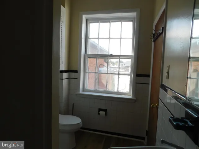 a bathroom with a toilet sink and window