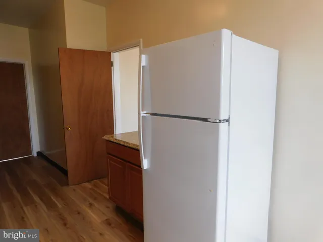a white refrigerator freezer sitting in a kitchen