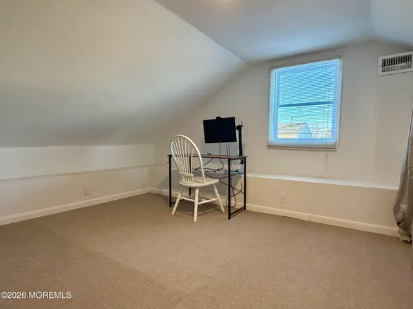 a view of a room with furniture and a window