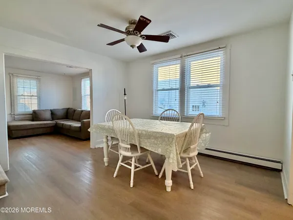 a view of a dining room with furniture window and wooden floor