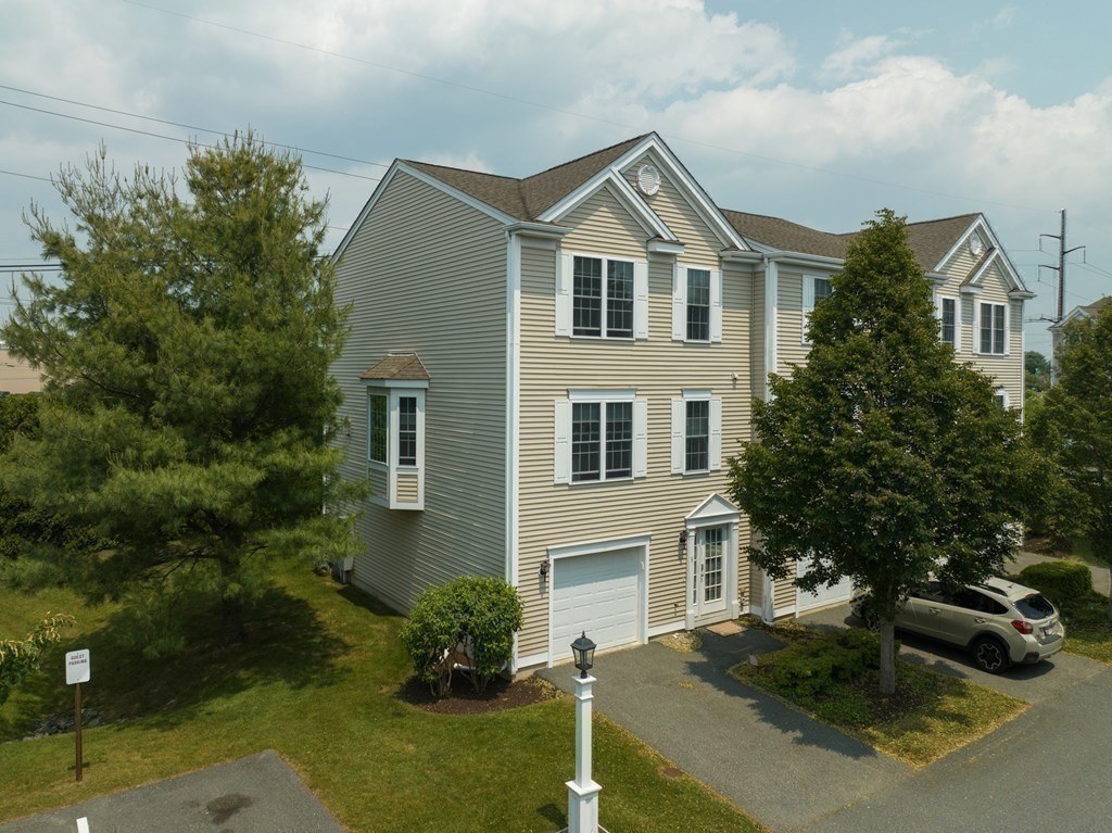 3 Harbor Mist Drive, Unit 3 Fairhaven, MA 02719 - Photo 1 of 28 a front view of a house with a yard garage and outdoor seating