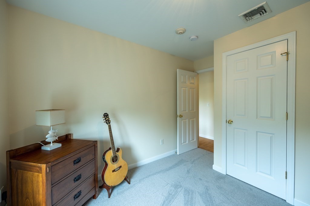 3 Harbor Mist Drive, Unit 3 Fairhaven, MA 02719 - Photo 20 of 28 a bedroom with a bed and cabinets