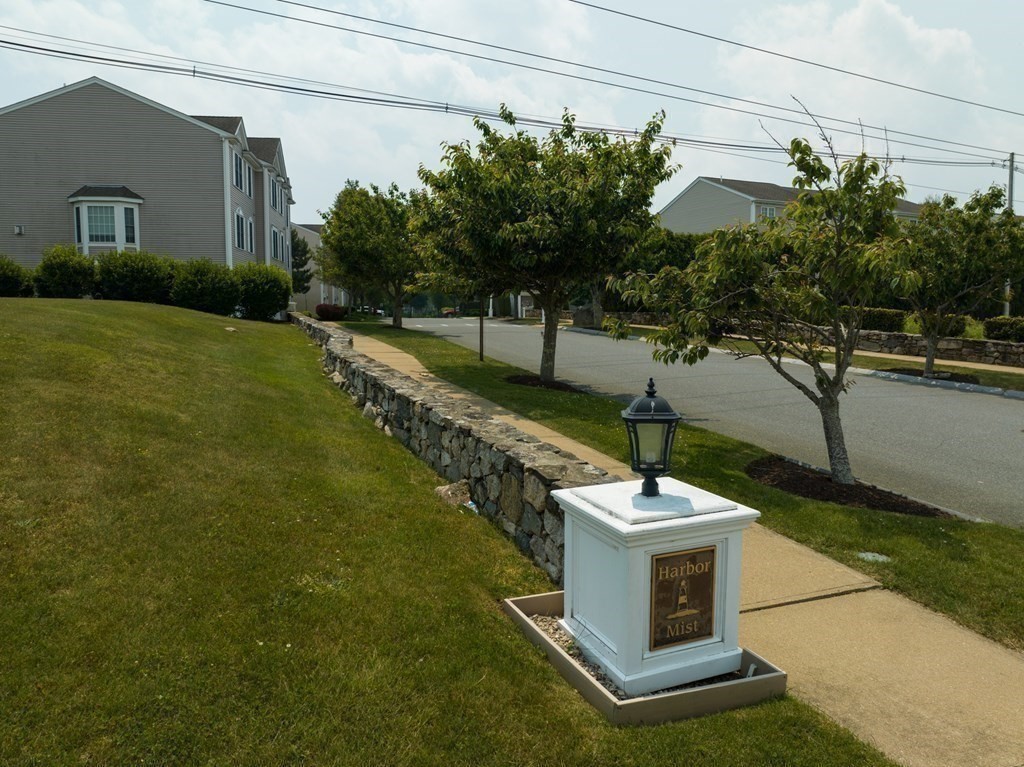 3 Harbor Mist Drive, Unit 3 Fairhaven, MA 02719 - Photo 2 of 28 a table and chairs sitting in front of a house