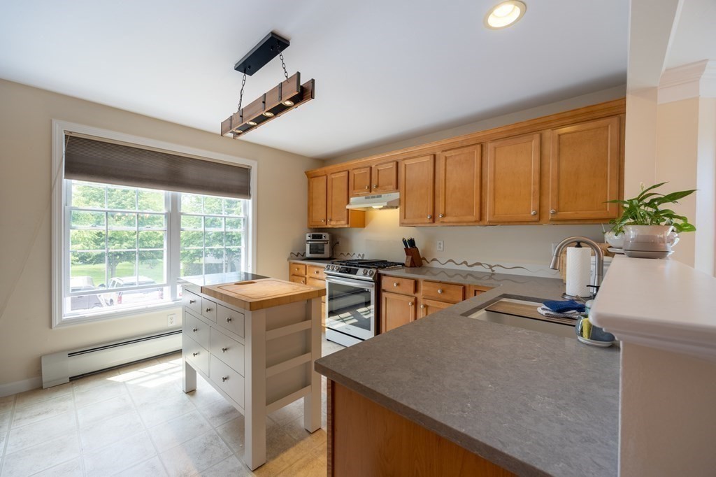 3 Harbor Mist Drive, Unit 3 Fairhaven, MA 02719 - Photo 10 of 28 a kitchen with a stove a sink and a refrigerator
