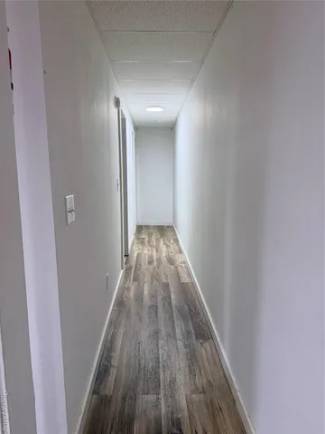 a view of gallery with wooden floor