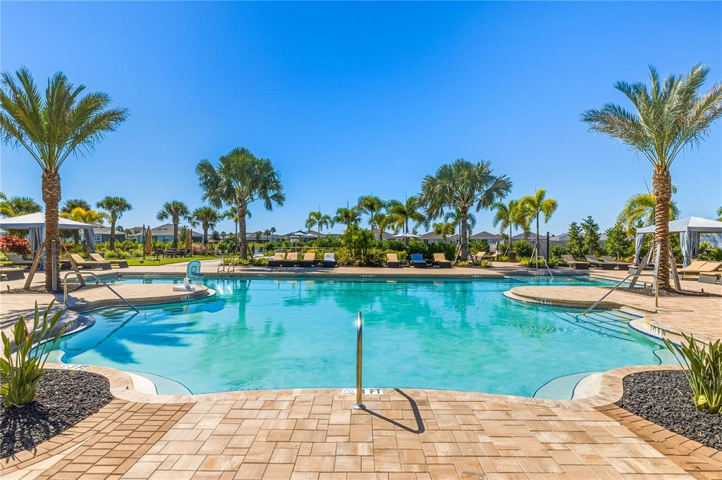 18318 Beach Ranch Terrace Lakewood Ranch, FL 34211 - Photo 28 of 40 a view of a swimming pool and lounge chairs