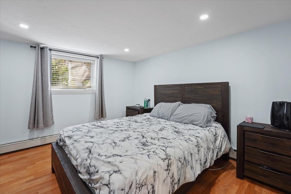 22 Westgate Road, Unit 2 Boston, MA 02467 - Photo 8 of 19 a bedroom with a bed and wooden floor