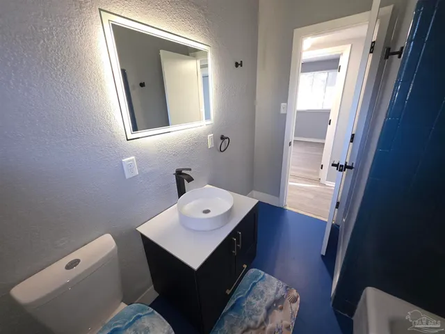 a bathroom with a sink toilet and mirror