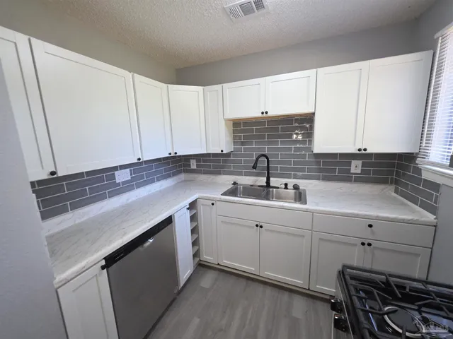 a kitchen with a sink cabinets and window