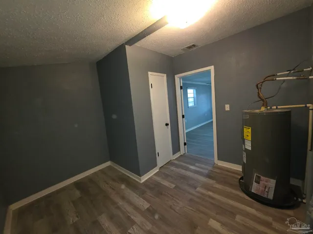 a view of a room with wooden floor