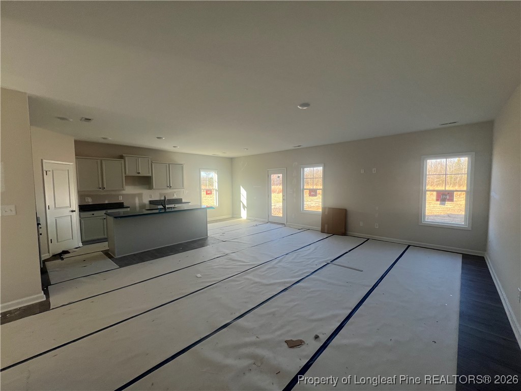4075 Blue Springs Red Springs, NC 28377 - Photo 7 of 28 a view of kitchen and empty room with windows