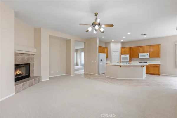 an empty room with closet and a chandelier fan