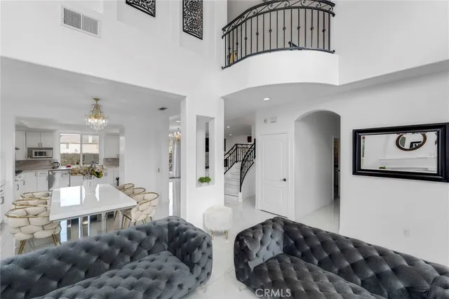 a bedroom with furniture and a large window