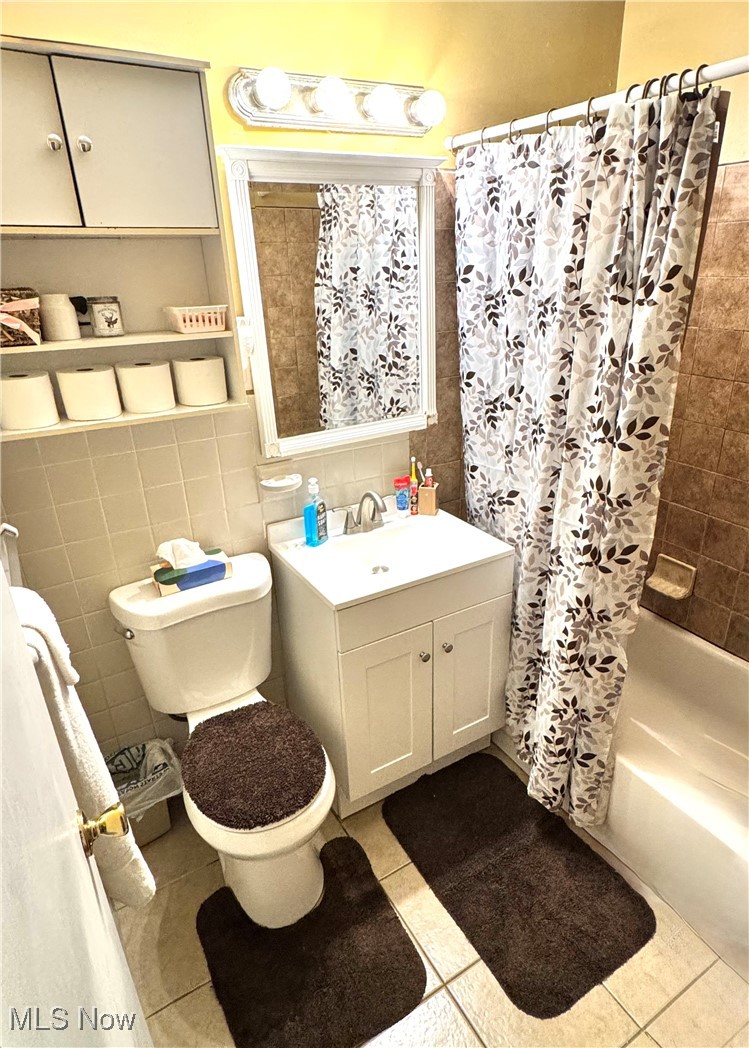 5945 Randy Road Bedford Heights, OH 44146 - Photo 12 of 13 Full bathroom featuring shower / bath combo, vanity, tile patterned floors, and tile walls
