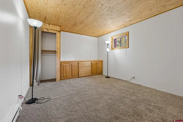 a bedroom with a bed and a ceiling fan