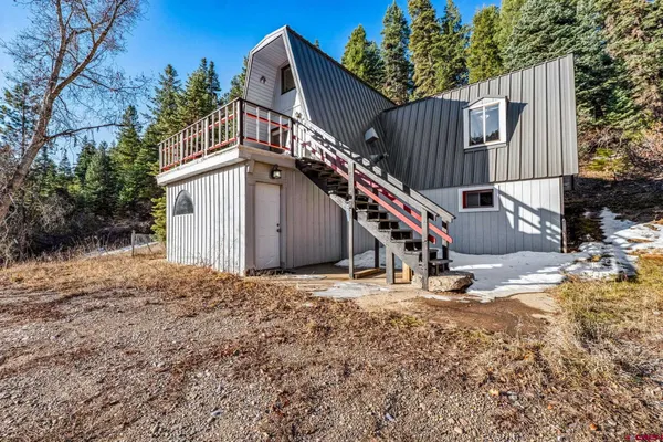 a kitchen with stainless steel appliances kitchen island granite countertop a refrigerator and a sink