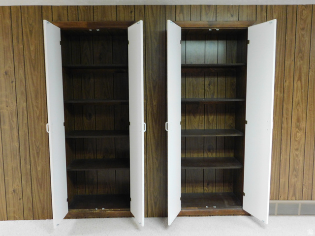 2148 Carolyn Way Bountiful, UT 84010 - Photo 26 of 40 Two wood-finish storage cabinets with white doors and interior shelving