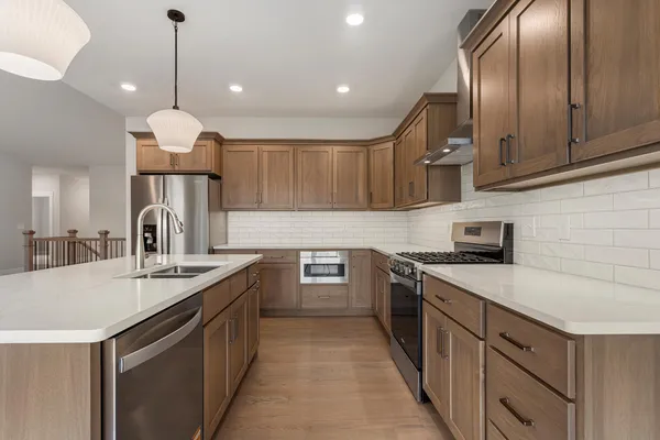 a kitchen with a sink stove and cabinets
