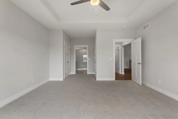 a view of empty room with ceiling fan