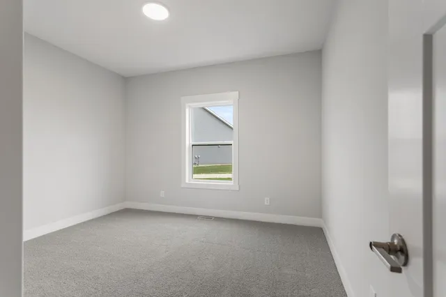 a bathroom with a toilet a sink a mirror and a shower