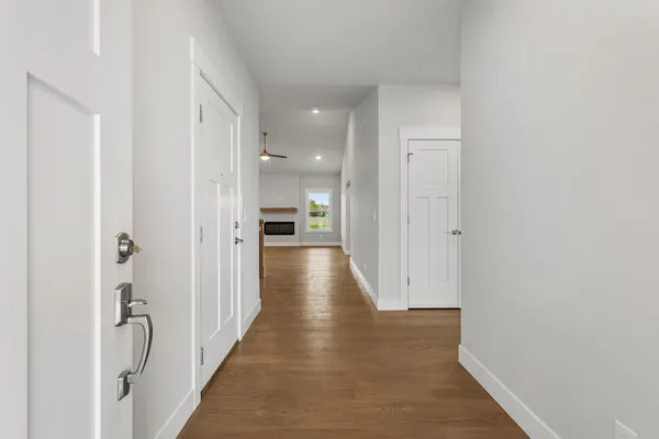 a view of a hallway with wooden floor