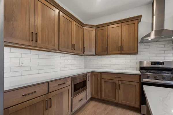 a kitchen with stainless steel appliances granite countertop a sink a stove and cabinets
