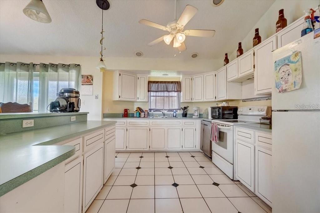 2950 Flounder Creek Road Mims, FL 32754 - Photo 11 of 29 a kitchen with cabinets and window
