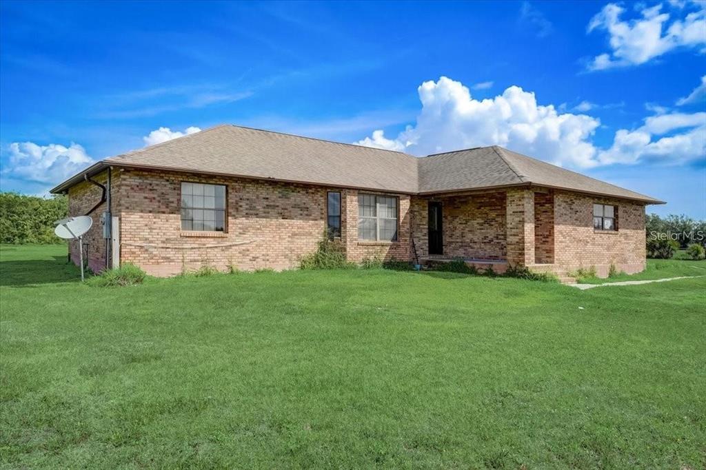 2950 Flounder Creek Road Mims, FL 32754 - Photo 2 of 29 a front view of a house with a garden