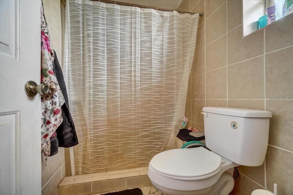 2950 Flounder Creek Road Mims, FL 32754 - Photo 21 of 29 a bathroom with a toilet and a shower