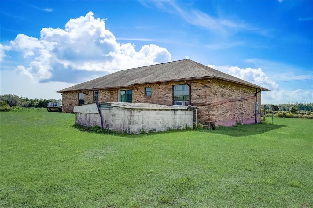 2950 Flounder Creek Road Mims, FL 32754 - Photo 24 of 29 a view of a house with backyard and garden