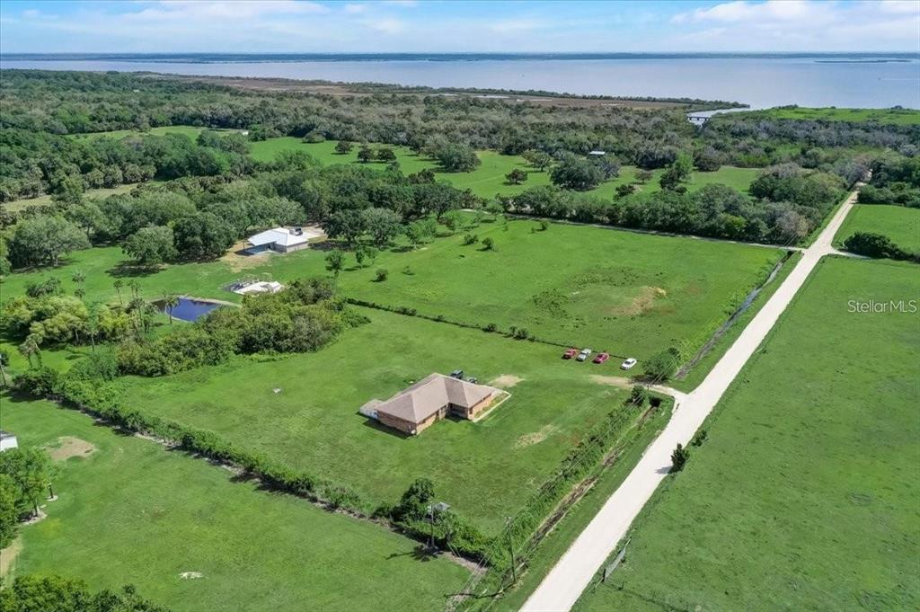 2950 Flounder Creek Road Mims, FL 32754 - Photo 28 of 29 a view of a big green field with lots of green bushes