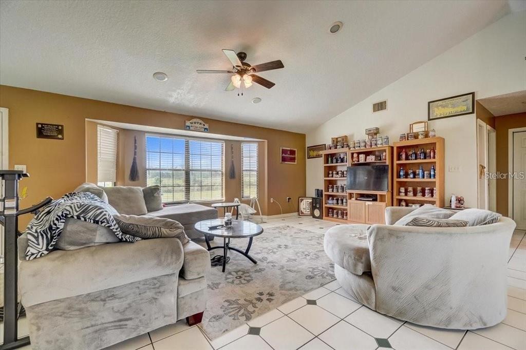 2950 Flounder Creek Road Mims, FL 32754 - Photo 3 of 29 a living room with furniture and a large window