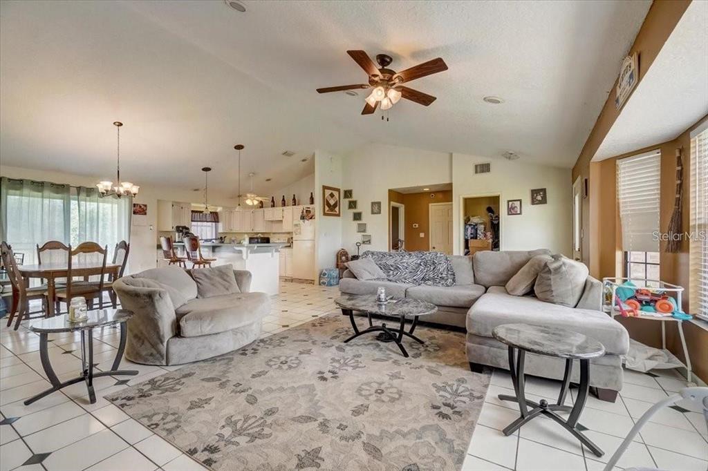 2950 Flounder Creek Road Mims, FL 32754 - Photo 5 of 29 a living room with furniture and a large window