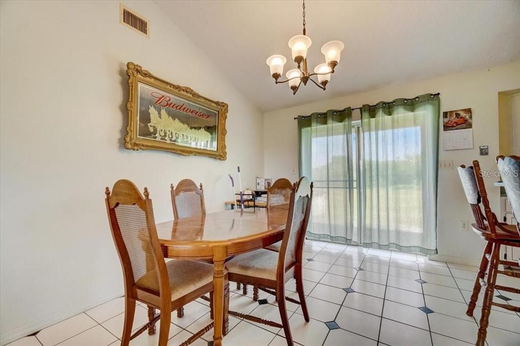2950 Flounder Creek Road Mims, FL 32754 - Photo 8 of 29 a view of a dining room with furniture and chandelier
