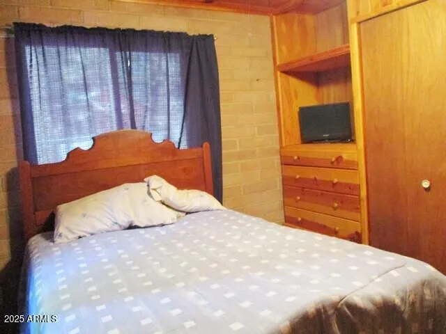 a bedroom with a bed and cabinets