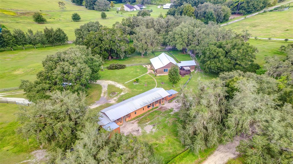 4292 Southwest 73rd Trail Bushnell, FL 33513 - Photo 64 of 85 an aerial view of a house with a yard and lake