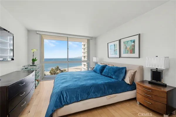 a bedroom with a bed and flat screen tv