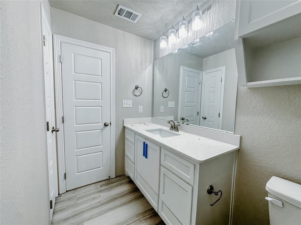 1341 Promised Land Road Hewitt, TX 76643 - Photo 13 of 34 a bathroom with a sink and a mirror