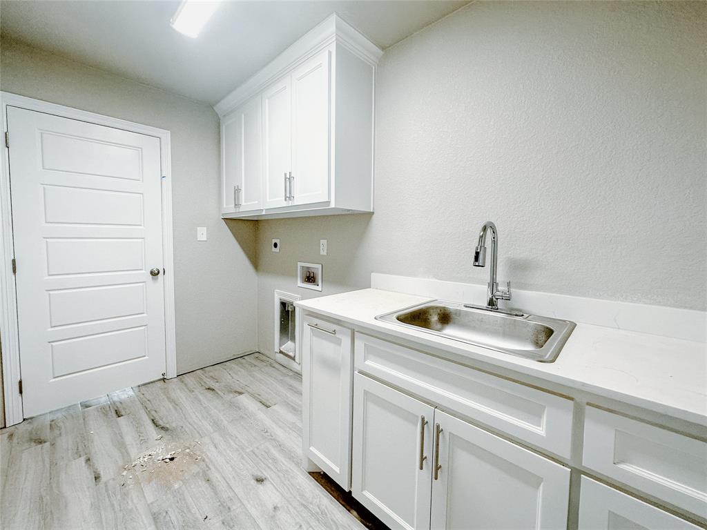 1341 Promised Land Road Hewitt, TX 76643 - Photo 16 of 34 a kitchen with a sink and cabinets