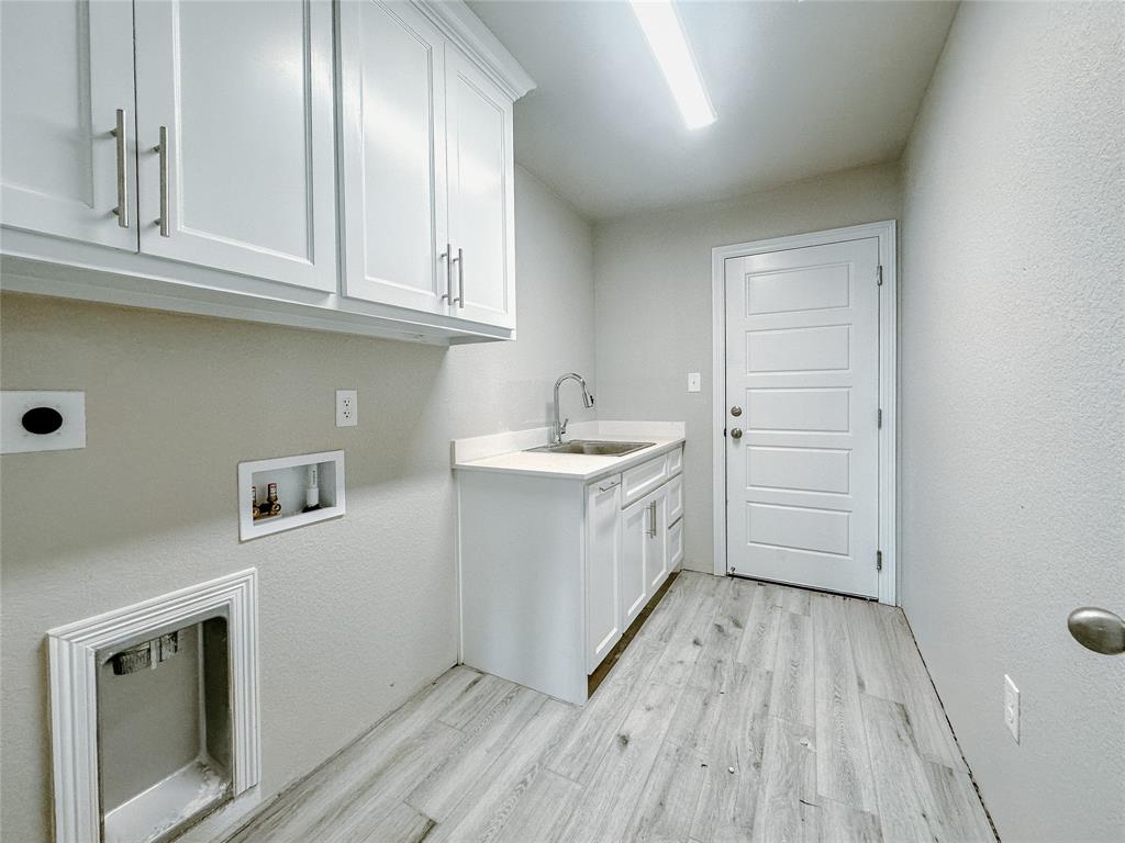 1341 Promised Land Road Hewitt, TX 76643 - Photo 17 of 34 a utility room with granite countertop a sink a stove and cabinets