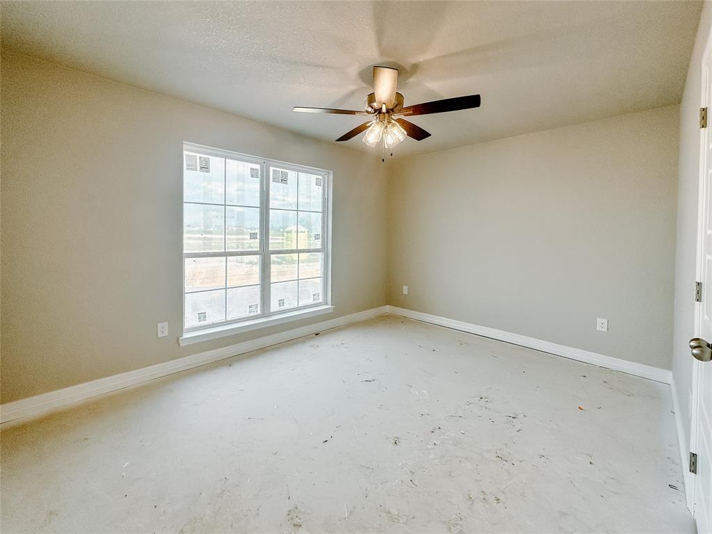 1341 Promised Land Road Hewitt, TX 76643 - Photo 19 of 34 an empty room with a window and a fan