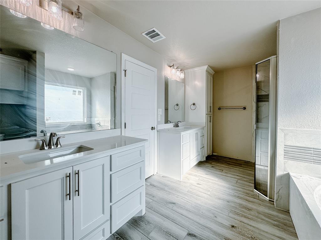 1341 Promised Land Road Hewitt, TX 76643 - Photo 21 of 34 a bathroom with a double vanity sink mirror and shower